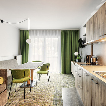 A modern kitchen and dining room table in a flat.