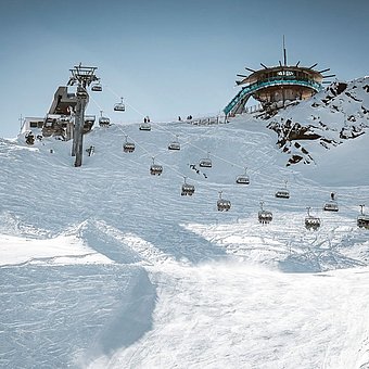 Skiers travelling on a ski lift.