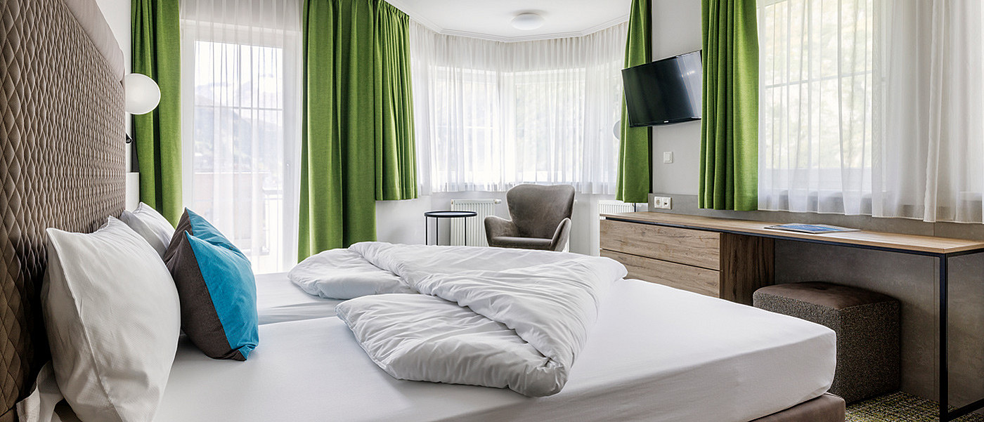 A large double bed in a flat.