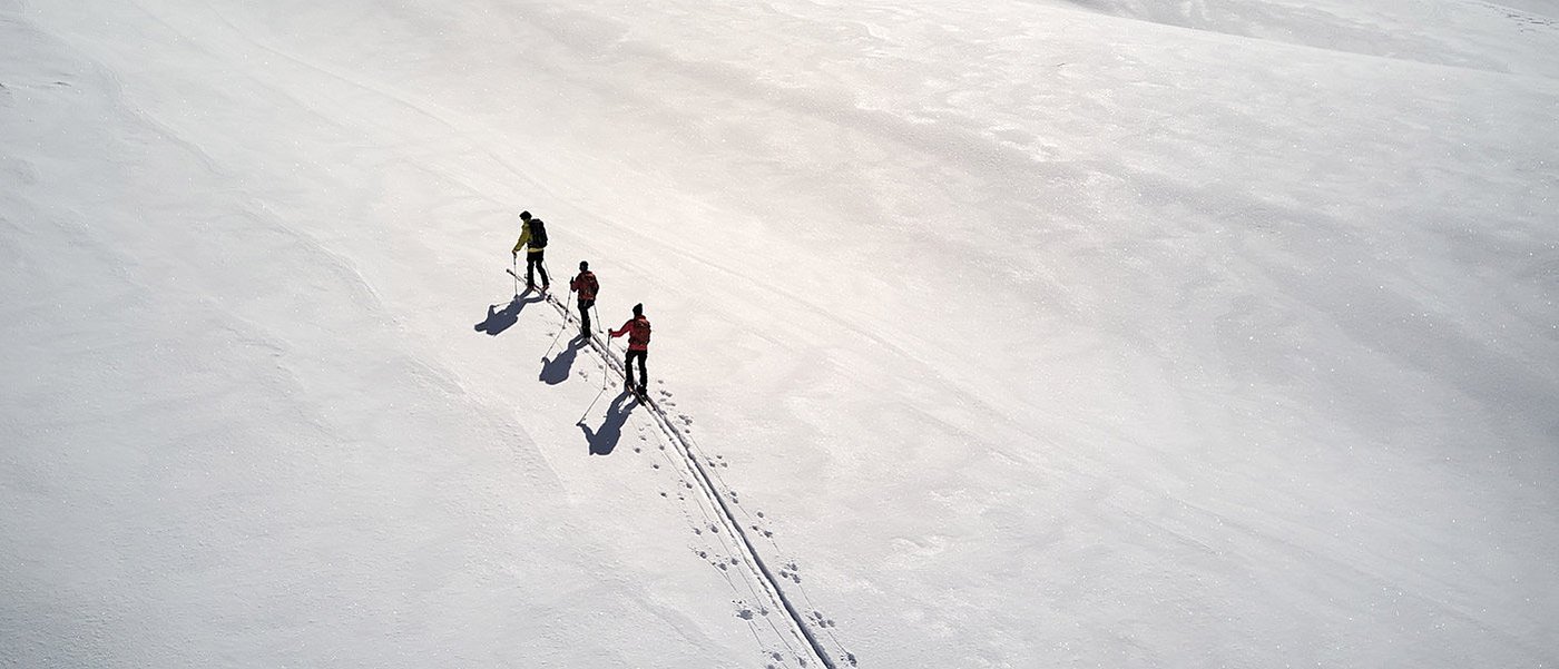 Three ski tourers on the ascent