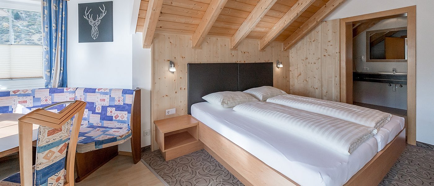 Suite with double bed and dining area.