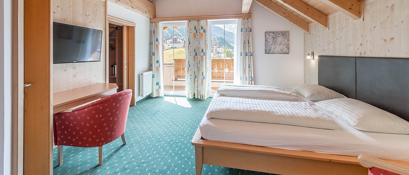 Cosy hotel room with television.