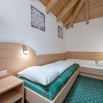 A room with two single beds in a hotel room.