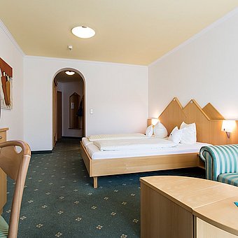 Ein Doppelbett und ein Fernseher in einem Hotelzimmer.