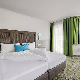 A modern bedroom with a large double bed.